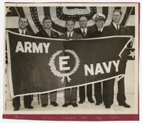Military and Firestone Representatives Holding Army-Navy “E” production Award Banner