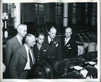 Military and Civilian Officials Viewing Manufacturing Equipment