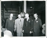 Military and Civilian Officials Examine Wartime Products